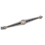 An early 20th Century sapphire and diamond bar brooch, central old cut diamond, weight approximately