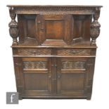 A 20th Century reproduction carved oak court cupboard, the central projecting section flanked by