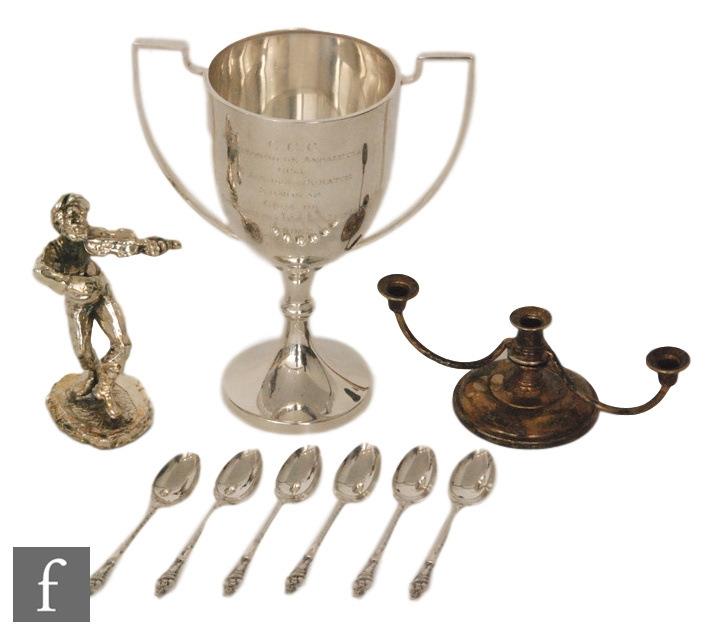 A hallmarked silver twin handled trophy cup with presentation engraving with a set of six silver