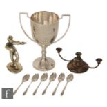 A hallmarked silver twin handled trophy cup with presentation engraving with a set of six silver