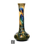 A Moorcroft Pottery vase of compressed form with an elongated neck decorated in the Phoenix Bird