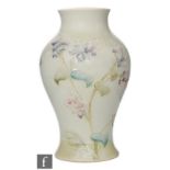 A William Moorcroft for Liberty & Co baluster form vase decorated in the Lilac pattern, with