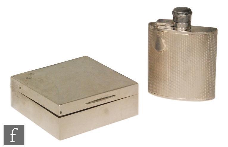 A hallmarked silver small hip flask with engine turned decoration to whole, height 9cm, with a