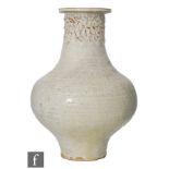 A post war studio pottery vase of baluster form with a textured collar neck with flat rim