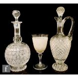 An early 20th Century clear glass decanter of footed ovoid form, with cut decoration including