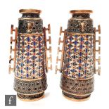 A pair of late 19th to early 20th Century Japanese bronze vases of footed tapered form, in the