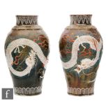 A pair of early 20th Century Japanese baluster form vases with everted rim, relief decorated in