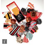 Twenty four assorted German silver, white metal and bronze medals and fobs to include a King Karl