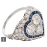 A platinum sapphire and diamond cluster ring, heart shaped head set with three central brilliant cut