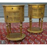 A pair of late 20th Century gilt painted bergere bedside cabinets of oval form, each fitted with a