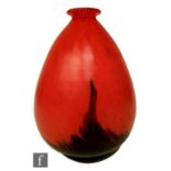 A contemporary studio glass vase of ovoid form with everted rim, with deep red rising up against the