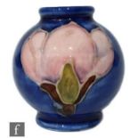 A post war Walter Moorcroft salesmans miniature vase of footed ovoid form, tubeline decorated in the