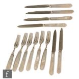 A set of six hallmarked silver and mother of pearl dessert knives and forks with carved shaped