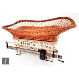 A set of early 20th Century baby weighing scales with wicker basket