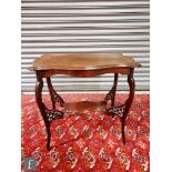 An early 20th Century mahogany occasional table of rectangular cartouche form, raised to cabriole