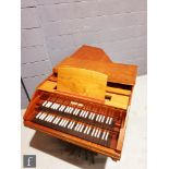 A 20th Century German walnut double manual harpsichord, raised to square tapered legs, the name