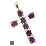 A 9ct cross set with seven oval amethyst stone to axis, length 5cm, weight 5g, unmarked.