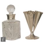 A hallmarked silver trumpet bud vase, circular base below three vases with crimped borders, height