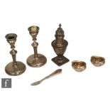 Six items of silver, a sugar castor, a pair of candlesticks, a pair of open salts and a small
