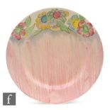 A Clarice Cliff circular plate circa 1938, hand painted in an unrecorded pattern with a band of