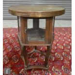 A 20th Century oak vitrine or bijouterie table of Middle Eastern design, the circular brass top