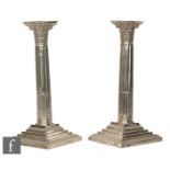 A pair of hallmarked silver Corinthian column candlesticks of typical form, height 24cm,