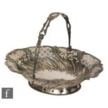 A George II hallmarked silver swing basket decorated with embossed ears of corn rising to pierced