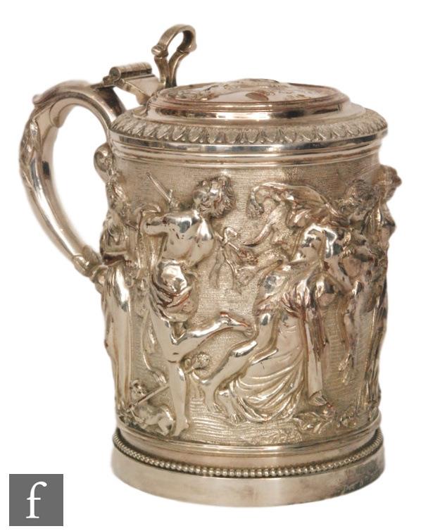 A 19th Century electroplated tankard of cylindrical form, richly embossed with a bacchanalian