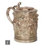 A 19th Century electroplated tankard of cylindrical form, richly embossed with a bacchanalian