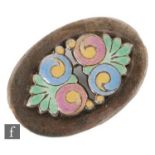 A silver oval brooch with central enamel decorated floral panel to a plain border, length 3cm,