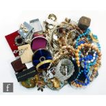 A parcel lot of assorted costume jewellery to include compacts, bangles, lighters, beads, brooches