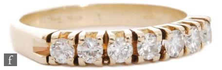 A 14ct diamond half eternity diamond ring, seven claw set, brilliant cut stones to plain