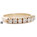 A 14ct diamond half eternity diamond ring, seven claw set, brilliant cut stones to plain