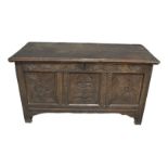 An 18th Century and later oak coffer chest, the replacement two plank hinged lid enclosing a