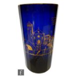 A 20th Century large glass vase of faceted sleeve form, the blue glass decorated with a gilt scene