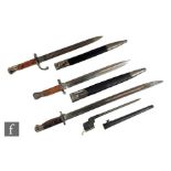 A 1913 Remington pattern bayonet, a similar bayonet, a Sanderson pattern bayonet and scabbard and