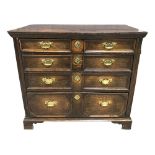 An 18th Century and later oak geometric panelled chest of two short over three long drawers, with