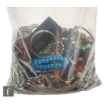 A large parcel lot of assorted modern costume jewellery to include beads, bangles, bracelets,