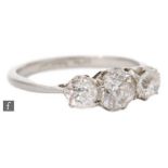 A platinum diamond three stone ring, old cut claw set stones, largest diameter approx 5mm, all to