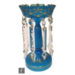 A19th Century Bohemian table lustre with wide circular foot rising to baluster form column and petal