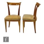 A pair of French 1950s satinwood chairs, attributed to Andre Arbus, with scroll backs and tapering