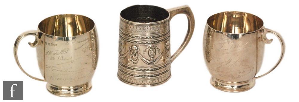 A pair of hallmarked silver half pint tankards each engraved with various signatures, with a similar