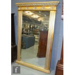 A 20th Century gilt and silvered painted Regency style pier mirror, the projecting cornice over a