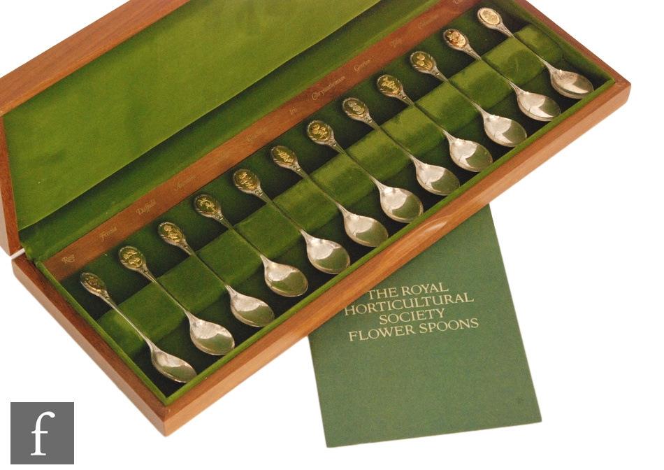 A cased set of twelve hallmarked silver tea spoons The Royal Horticultural Society Flower Spoons,