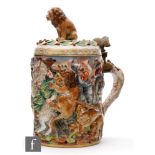 A Capo di Monte lidded tankard decorated in the round with a relief moulded battle scene, the lid