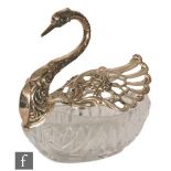 A glass dish with silver swan mounts, swan's head and neck embossed with foliate scrolls with two