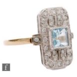 An 18ct hallmarked Art Deco style aquamarine and diamond cluster ring, central collar set square cut