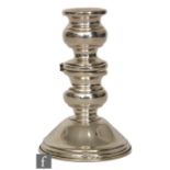 A continental silver novelty candlestick, circular stepped base below hinged mid section to