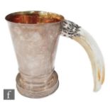 An early 20th century silver Eastern tankard of plain tapering cylindrical form mounted with a
