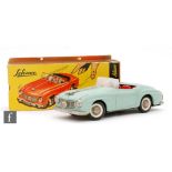 A Schuco Rollyvox 1080 tinplate clockwork open top sports car, the turquoise body with red plastic